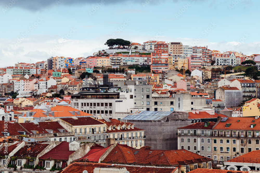 Many buildings with red roofs built on the hill