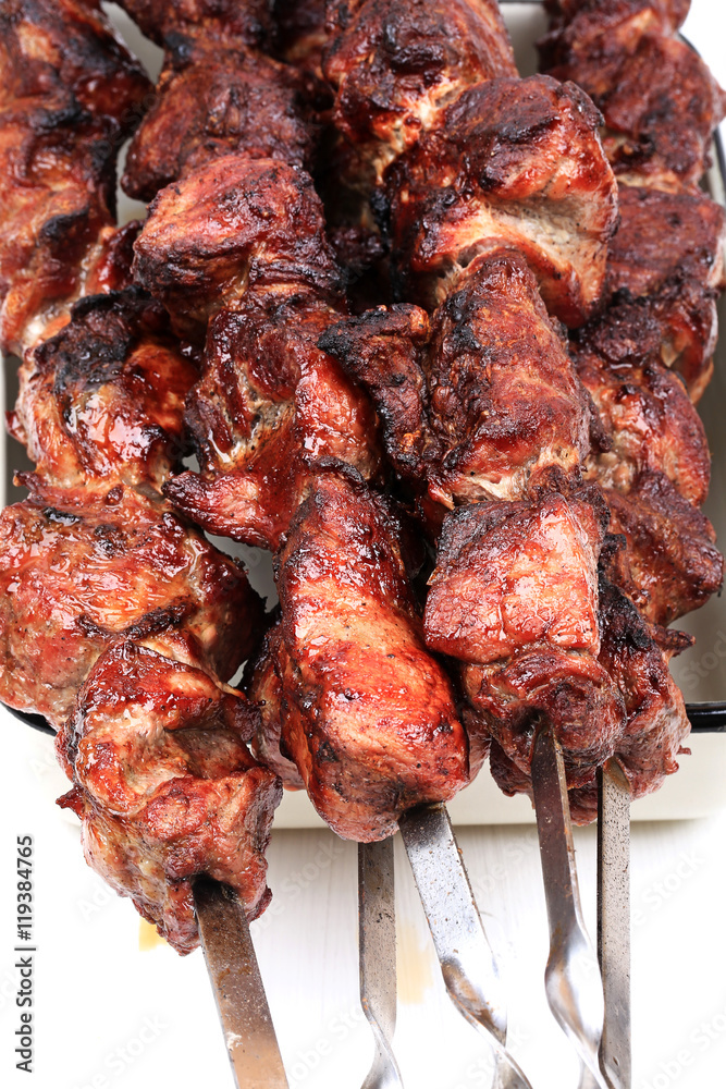 barbecue skewers on a white wooden background top view top view shallow depth of field