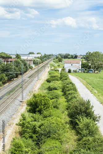 View of railroad track from steel net of a bridge