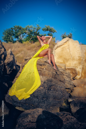beautiful woman in yellow cloth on the rock