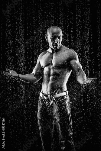 very muscular handsome athletic man in the rain © Andriy Petrenko