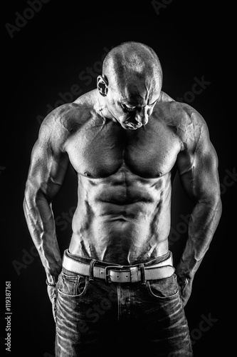 very muscular handsome athletic man on black background