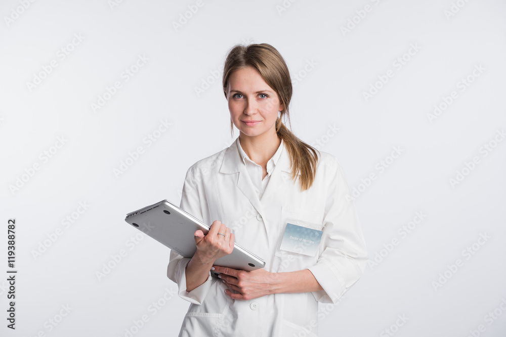 Woman doctor with papers and laptop isolated on the white Woman doctor with papers and laptop isolated on the white
