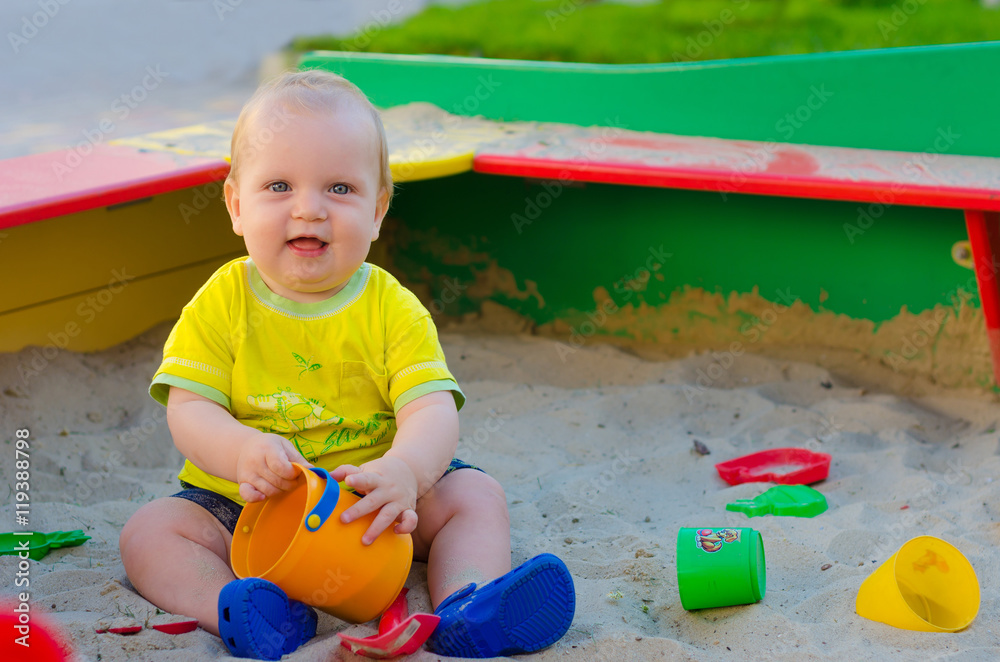Toddler Boy playing in a sandbox Toddler Boy playing in a sandbox