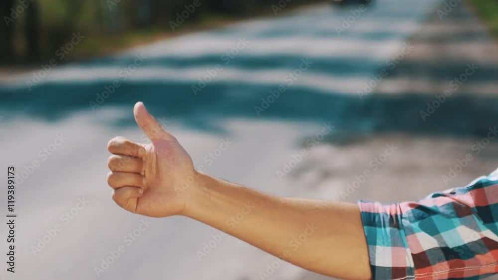 Portrait boy hitchhiking at road in summer day. Travel. Thumb up. Transportation. Countryside. Portrait boy hitchhiking at road in summer day. Travel. Thumb up. Transportation. Countryside.