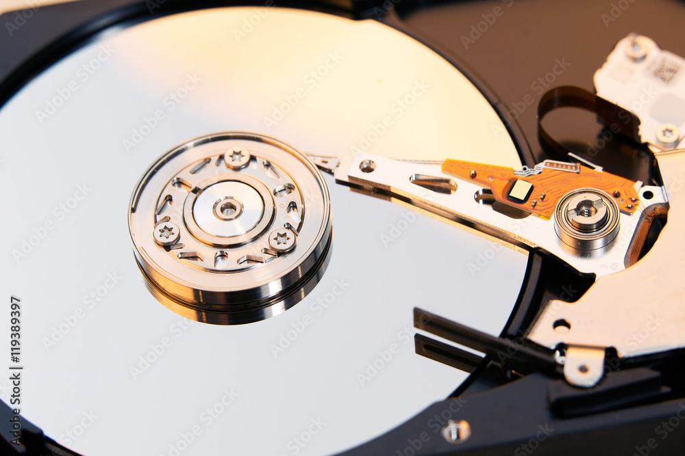 Close up of a hard disk drive reading and writing data.