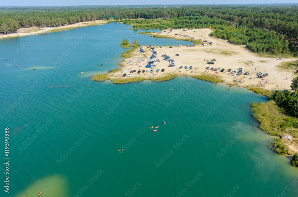 Aerial view onto beach on so-calles Blue Lake and people swim on inflatable mattresses