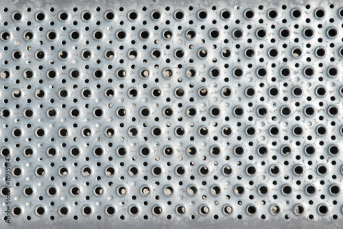 Grunge polished metal doted background