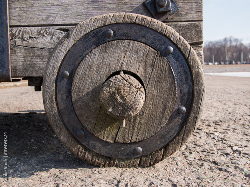 Close up of an old wooden wheel with an iron rim that suited in the hub of the wooden carts