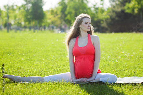 Beautiful pregnant woman in yoga pose