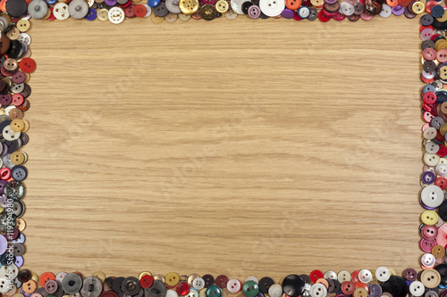 Wooden background with a colorful button border