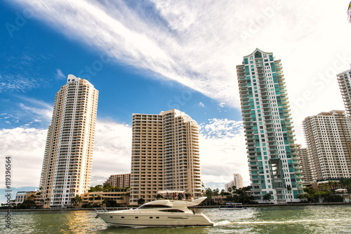 Downtown Miami along Biscayne Bay with condos and office buildings, yacht sailing in the bay