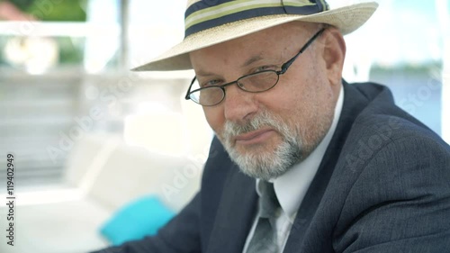 Wallpaper Mural Portrait of eldery man in hat and glasses smiling and nodding on camera. 4K Torontodigital.ca