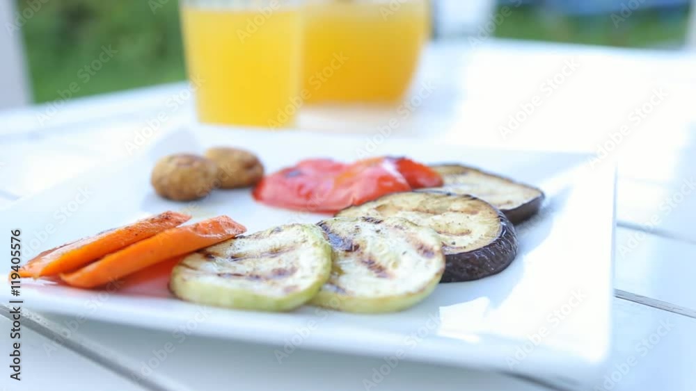 Grilled vegetables on the white plate on the wood table. Grilled vegetables on the white plate on the wood table.