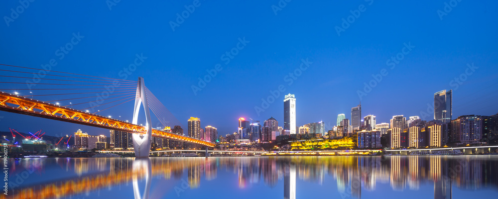 cityscape and skyline of chongqing from water at night