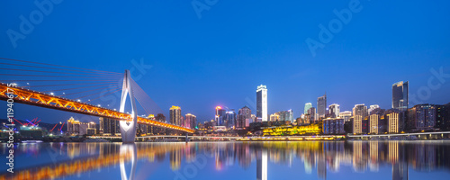 cityscape and skyline of chongqing from water at night photo