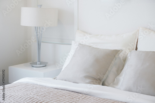 Light gray pillow setting on bed in nice vibe bedroom modern interior style