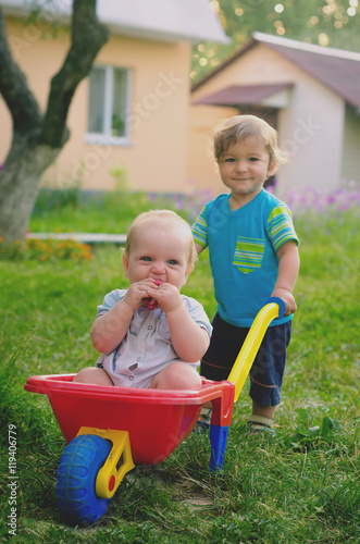 Two little boys toddler playing with colorful children's plastic