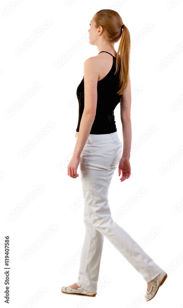 back view of walking  woman  in  white jeans and shirt. beautiful blonde girl in motion.  backside view of person.  Rear view people collection. Isolated over white background.