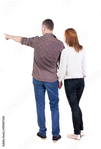 young couple pointing. Back view.  Rear view people collection.  backside view of person.  Isolated over white background.