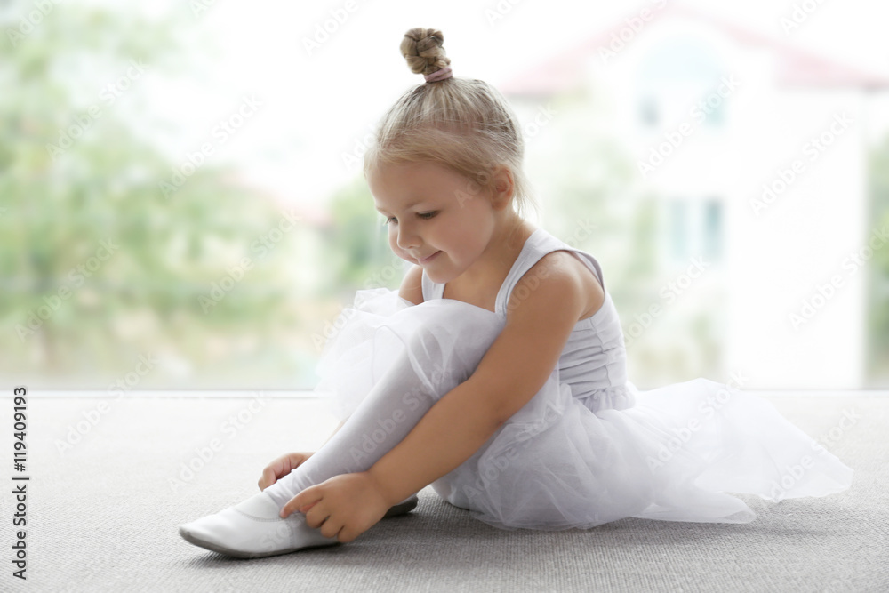 Cute ballerina sitting on the floor at ballet class Cute ballerina sitting on the floor at ballet class