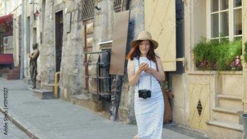 holidays and tourism - beautiful girl with phone, tourist book and vintage camera in the city photo
