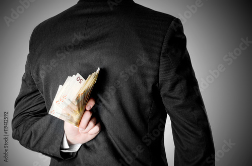 Businessman Dressed in Suit Hiding Fifty Euro Bank Notes