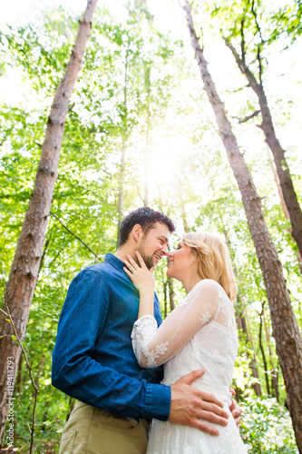 Beautiful wedding couple outside in green forest. © Halfpoint