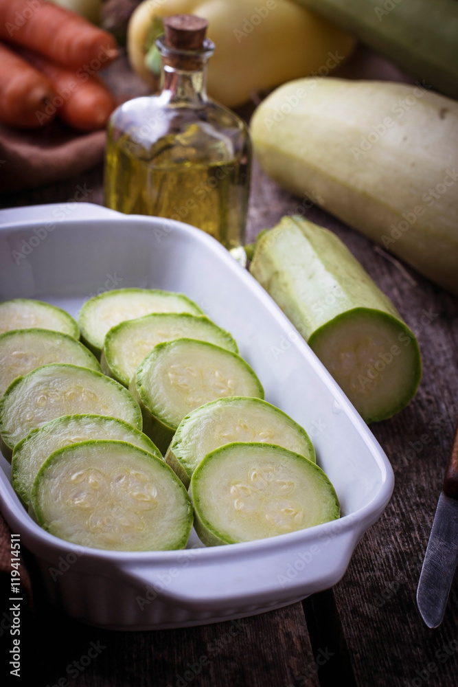 Sliced zucchini in baking dish Sliced zucchini in baking dish