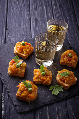 Canape with eggplant caviar and glasses of wine