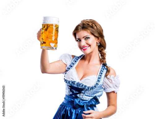 Woman in traditional bavarian dress holding mug of beer photo