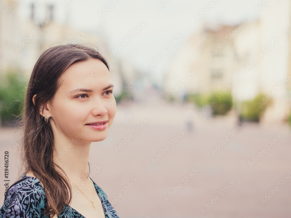 Close up of smiling young woman looking away Close up of smiling young woman looking away