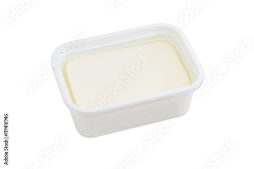 Container of feta cheese on a light background