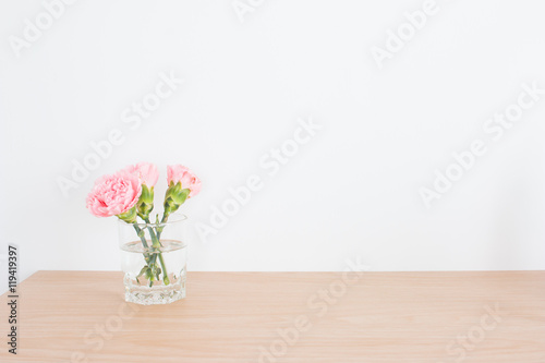 Pink carnations in the vase and blank easel