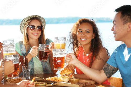 Group of friends hanging out together outdoors © Africa Studio