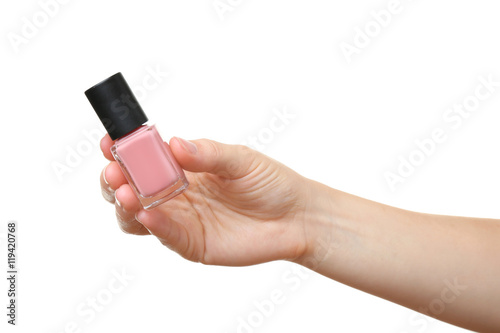 Female hand holding nail polish isolated on white