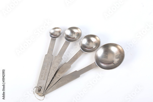 Steel measuring spoons on white background,selective focus