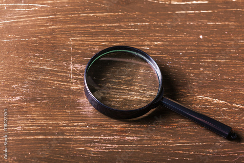 magnifying glass on the wooden background