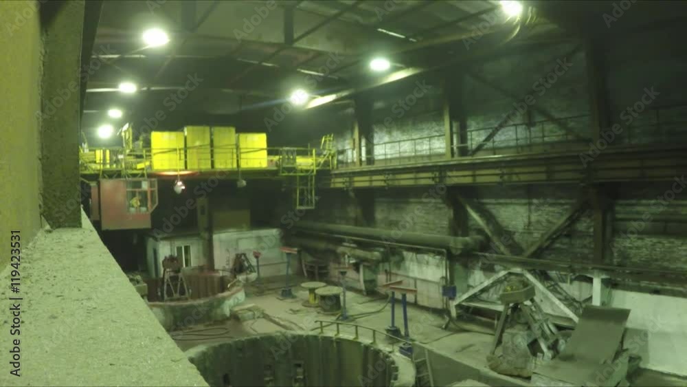 Grab crane with cargo passes by camera
