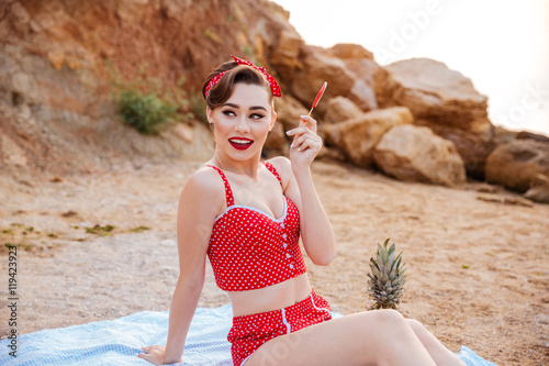Smiling pin-up girl having great time at the beach