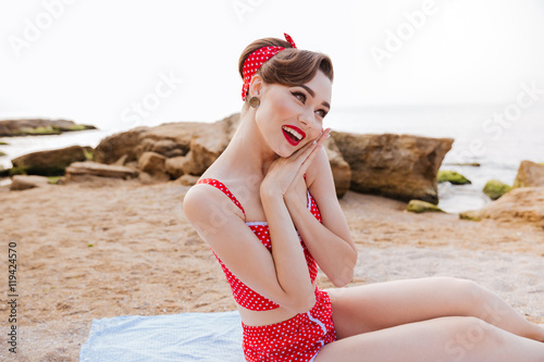 Portrait of lovely cute pin up girl in red swimsuit