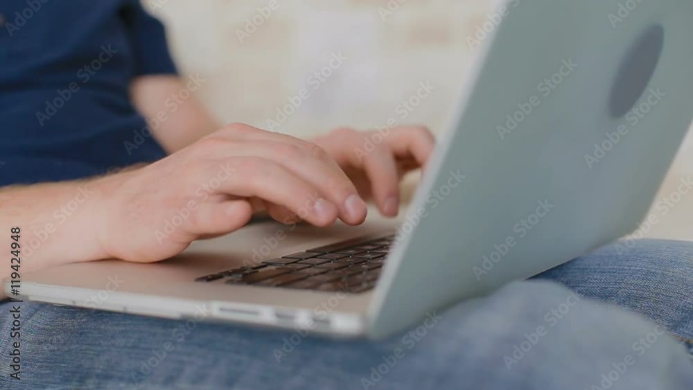Close-up of the man which prints something on the laptop. Close-up of the man which prints something on the laptop.
