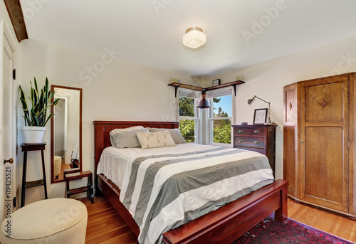 Bedroom interior with queen size wooden bed