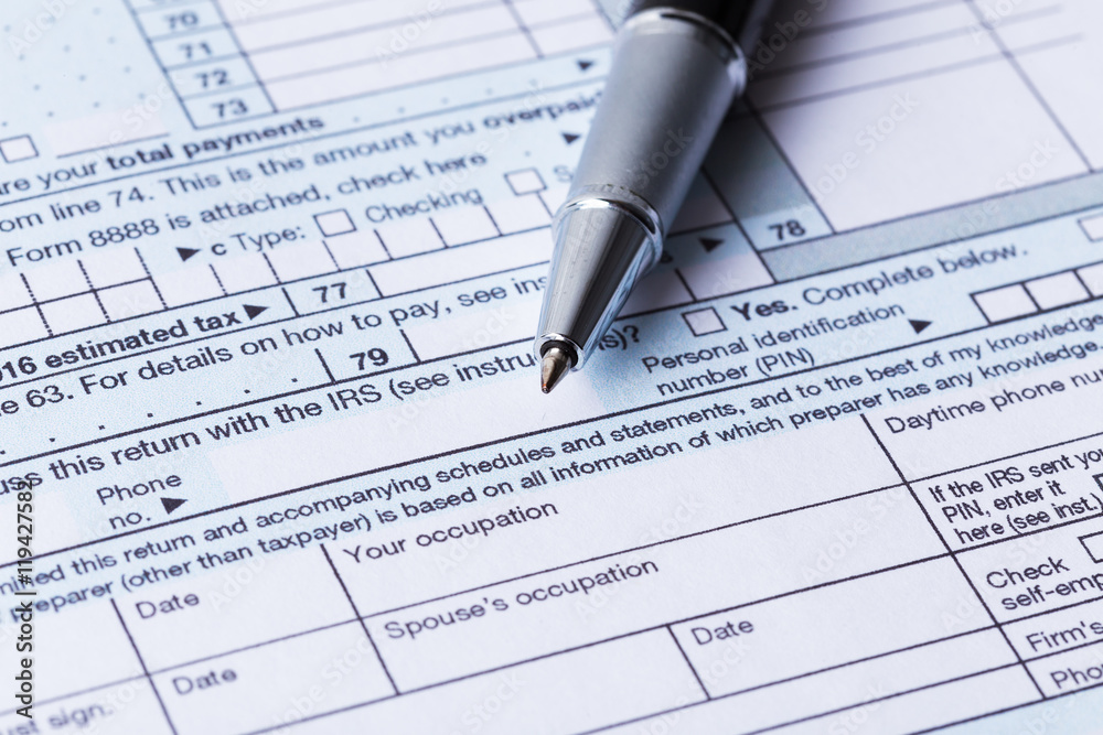 Income tax form and pen Income tax form and pen