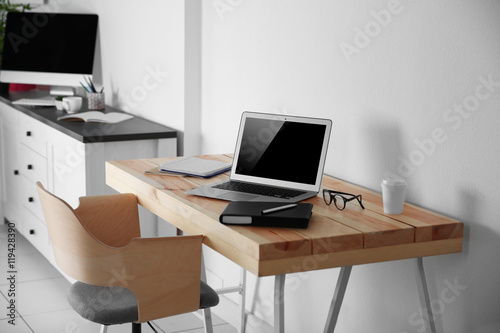 Working place on white wall background © Africa Studio