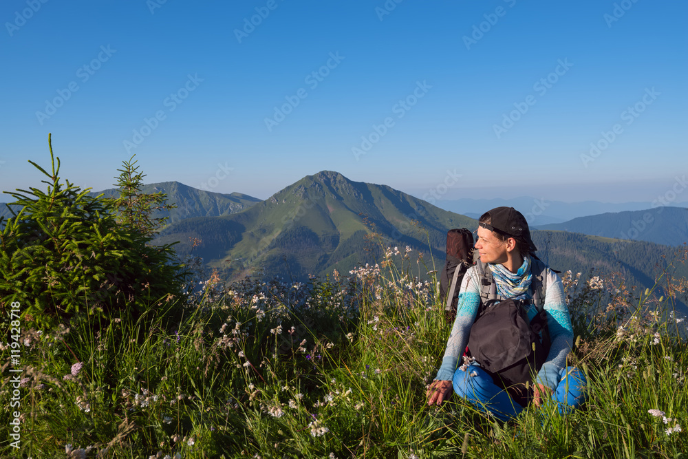 Woman hiker resting on a meadow Woman hiker resting on a meadow