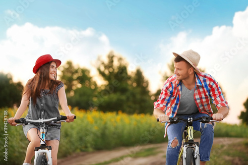 Young couple on bicycles in...