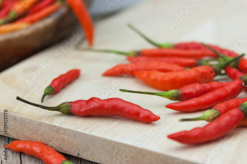 Red chili Peppers on wood chopping background