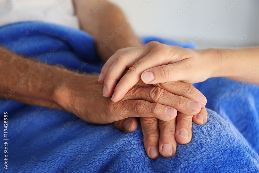 Old male and young female hands, closeup Old male and young female hands, closeup