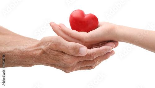 Old male and young female hands with heart figure on white background